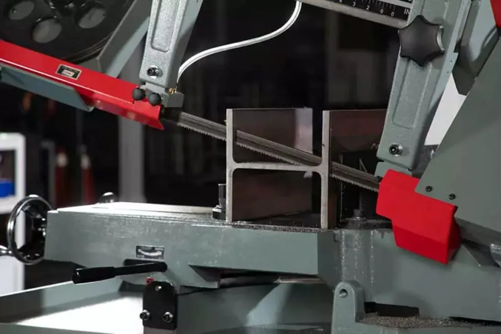 This is an image of a horizontal metal cutting bandsaw cutting some H beam to represent the concept of band saw safety